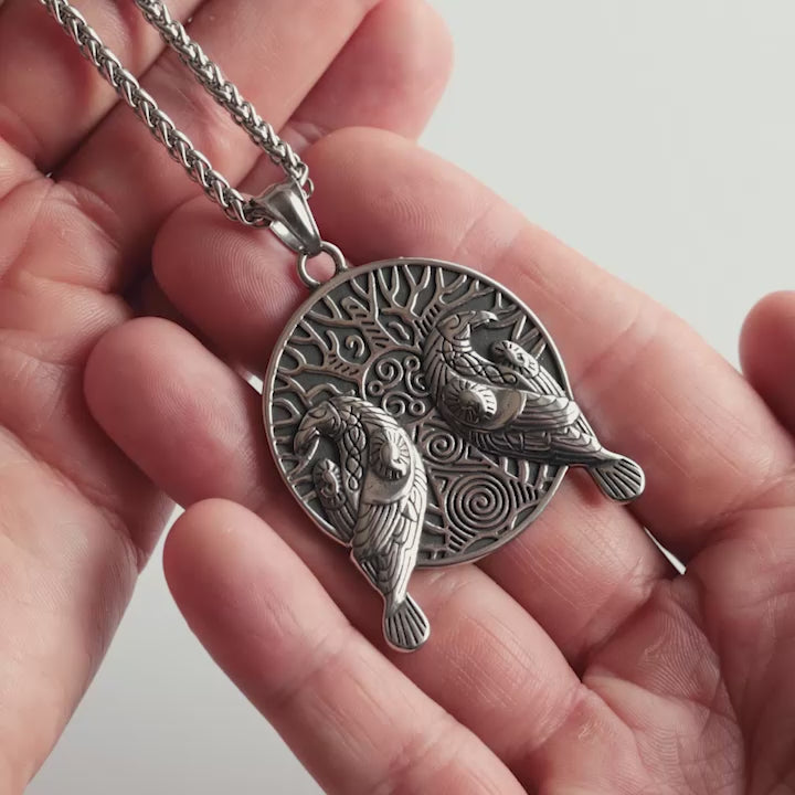 Odin Trinkets close-up video of silver stainless steel Viking necklace featuring Odin’s ravens Hugin and Munin with Yggdrasil tree of life design, Norse mythology inspired jewelry for men