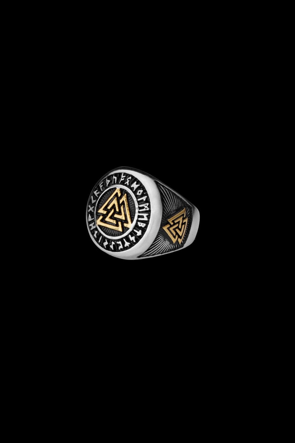  A stainless steel ring showcasing the Valknut symbol in gold, surrounded by engraved Elder Futhark runes. The side features additional Valknut engravings, highlighting its connection to Norse mythology.