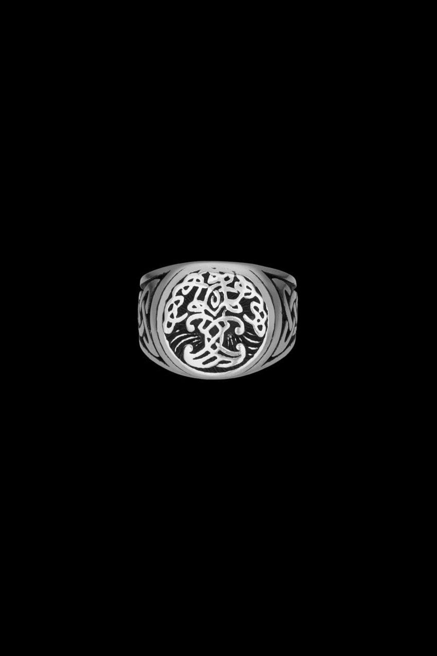 Stainless steel Yggdrasil ring featuring an intricately designed Tree of Life symbol at the center, flanked by knotwork patterns on the sides. The detailed craftsmanship embodies Norse mythology and symbolizes interconnectedness and eternity. Available at Odin Trinkets.