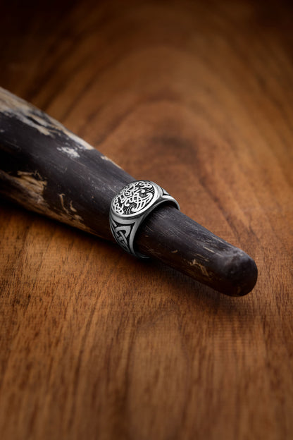  A Yggdrasil ring featuring an intricately engraved Tree of Life design, symbolizing Norse mythology's interconnectedness of life and the cosmos. The stainless steel band is adorned with Celtic knotwork on the sides for an authentic Viking-inspired look. Available at Odin Trinkets.